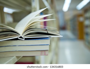 library with stack of books opened.