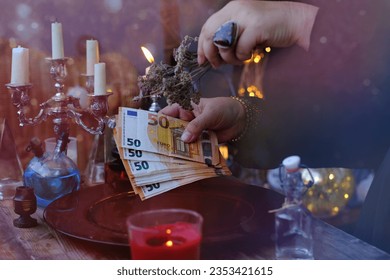 Librate with money, female hands of psychic doing witchcraft passes with euro banknotes, esoteric Oracle performs ritual of removing spell of black magic, esoteric business, magic to increase income