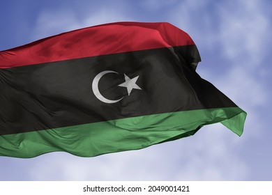 Libya flag isolated on the blue sky with clipping path. close up waving flag of Libya. flag symbols of Libyan.