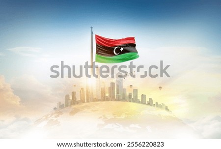 Libya flag wavering on globe with modern building skyline. Flag waving on world map. Libya national flag for independence day.