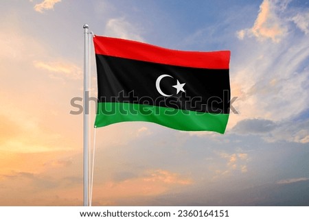Libya flag waving on sundown sky