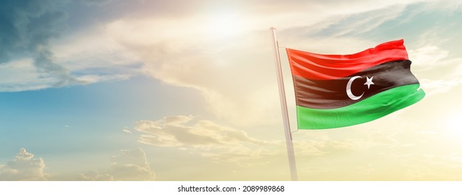 Libya national flag waving in beautiful sky.