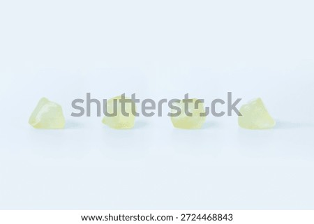 Libyan Desert Glass from different angles, isolated on white background.