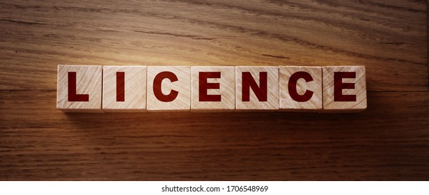 Licence Word Written In Wooden Cubes. Driver's licence or legal software concept.