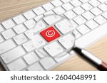 License. Computer keyboard with Copyright sign on red button, view through magnifying glass