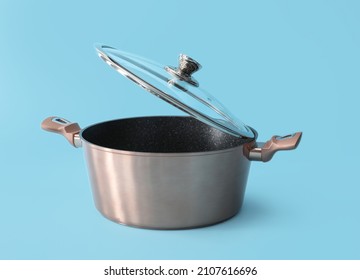 Lid and stainless cooking pot on color background - Shutterstock ID 2107616696