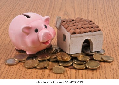 Life Annuity Concept With A Piggy Bank, A House And Coins