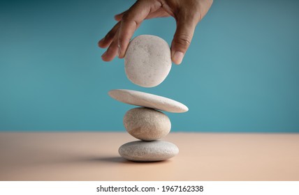 Life Balance Concept. Hand Setting White Natural Zen Stone Stack. Balancing Mind, Soul and Spirit. Mental Meditation Practice