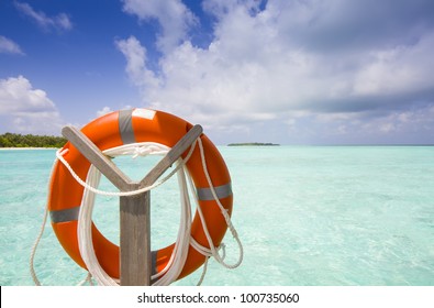 life belt at the sea with island blue sky and clouds
