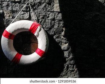 Life Buoy Attached Stone Wall In A Swiming Pool. Close Up