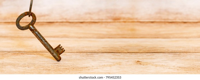 Life coaching concept - key standing on a wooden background - web banner with blank, copy space