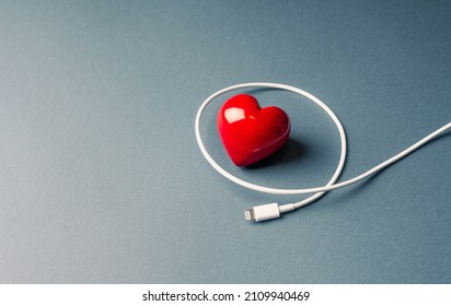 Life energy or Tiredness and its recharging concept with heart symbol and usb cable.
