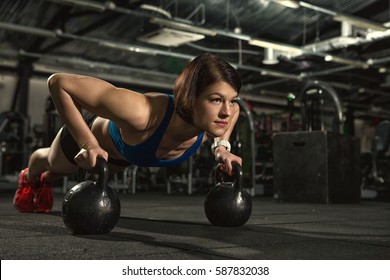 Life Of Fitness. Attractive Young Gym Fitness Woman Doing Push-ups With Weights Beautiful Sportswoman Doing Crossfit Workout Pushup Exercise With Kettlebells Copyspace Sport Lifestyle Strength Success