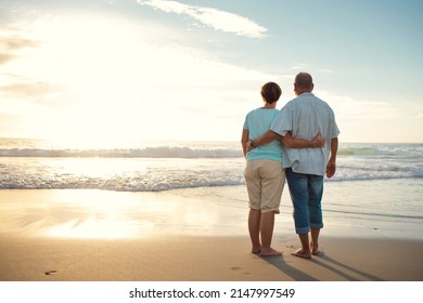 Life Is Full Of Beauty. Notice It. Rearview Shot Of A Couple Admiring The View While At The Beach.