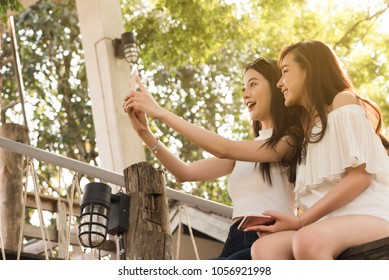 Life Of Generation Y Teenagers Hang Out In Coffee Shop Use Smartphone Play Social Media Sharing Digital Content To Each Other With Fun Take Selfie Shot