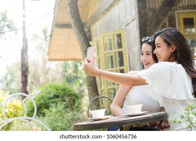 Life Of Generation Y Teenagers Hang Out In Coffee Shop Use Smartphone Play Social Media Sharing Digital Content To Each Other With Fun Take Selfie Shot