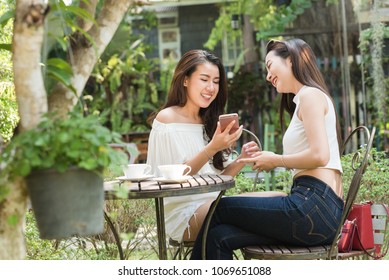 Life Of Generation Y Teenagers Hang Out In Coffee Shop Use Smartphone Play Social Media Sharing Digital Content To Each Other With Fun