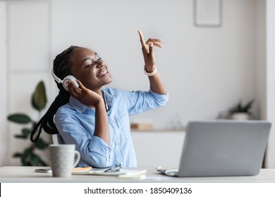 Life Is Good. Cheerful Black Female Entrepreneur Listening Music At Workplace And Dancing, Happy African Business Lady Wearing Headphones In Office, Sitting With Eyes Closed, Enjoying Favorite Songs - Shutterstock ID 1850409136