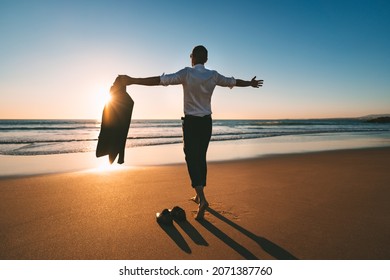 Life is good. Man with open arms enjoying life and freedom on the beach with sunset - Powered by Shutterstock