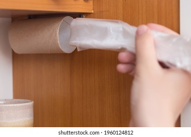 A Life Hack For Organizing Space In The Kitchen, Using A Toilet Paper Sleeve To Store Disposable Cellophane Bags.