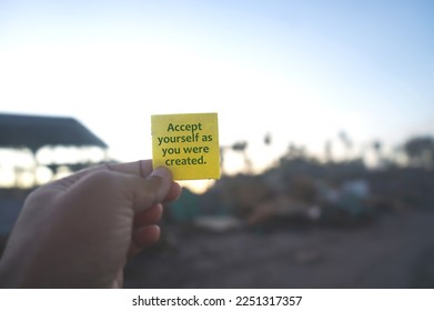 Life inspirational and motivational quote - Accept yourself as you were created. With person holding yellow card in hand. Self confidence concept. Self love and care. Love yourself concepts. - Shutterstock ID 2251317357