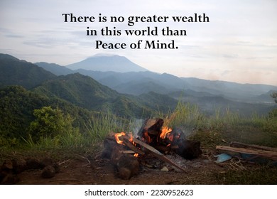 Life inspirational and motivational quote - There is no greater wealth in this world than peace of mind. With bonfire on camping activity in the mountains. - Shutterstock ID 2230952623