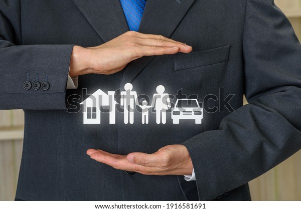 Life insurance, family protection, financial\
concept : Broker or insurer uses both hands to protect parents e.g.\
father, mother, child, a house and sedan car, depicts buying\
protection plan for safety