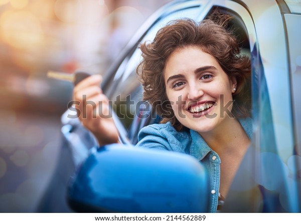 Life is a journey and you\
hold the keys. Shot of a happy young woman holding the keys to a\
new car.