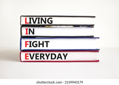 LIFE living in fight everyday symbol. Concept words LIFE living in fight everyday on books on a beautiful white table white background. Business LIFE living in fight everyday concept. Copy space.