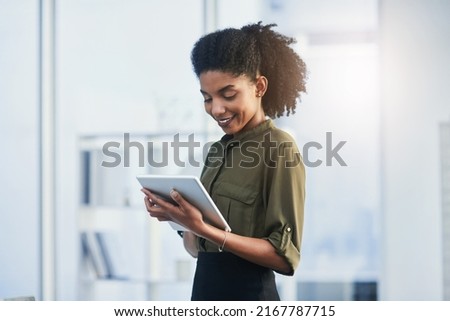 Life made easier with the touch of a button. Shot of a young businesswoman using her digital tablet in a office.