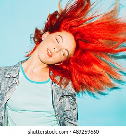 Life is motion. Bright girl with red hair. Stylish Hair
