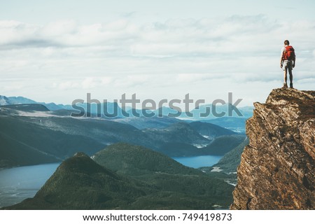Life on the edge Traveler on cliff mountains over fjord enjoying Norway landscape Travel Lifestyle success motivation concept adventure active vacations outdoor