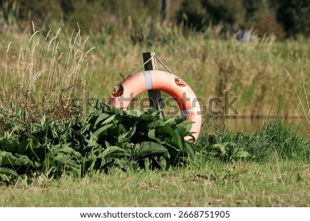 Life preserver floatation device situated at an inland lakeside location