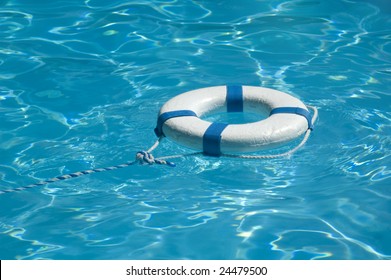 Life Ring Floating On Top Of Sunny Blue Water