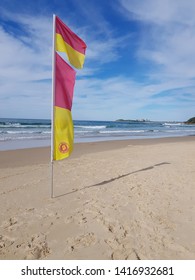 A Life Savers Flag On A Beach In Australia.