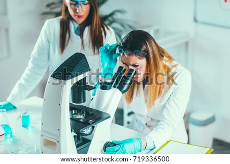 Life science research, placing sample under the microscope