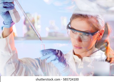 Life Scientists Researching In Laboratory. Focused Female Life Science Professional Pipetting Solution Into The Glass Cuvette. Lens Focus On Researcher's Eyes. Healthcare And Biotechnology Concept.