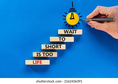 Life Is Short To Wait Symbol. Concept Words Life Is Too Short To Wait On Wooden Blocks On A Beautiful Blue Table Blue Background. Businessman Hand. Business Motivational Life Or Wait Concept.