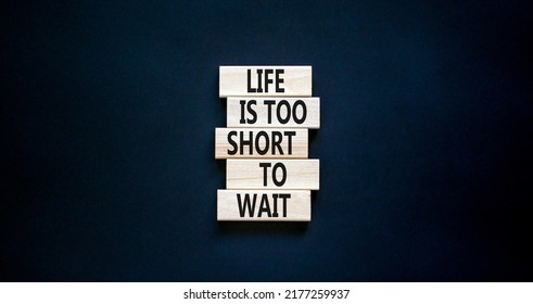 Life is short to wait symbol. Concept words Life is too short to wait on wooden blocks on a beautiful black table black background. Copy space. Business motivational life or wait concept.
