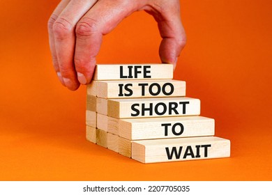 Life Is Short To Wait Symbol. Concept Words Life Is Too Short To Wait On Wooden Blocks On A Beautiful Orange Table Orange Background. Businessman Hand. Business Motivational Life Or Wait Concept.