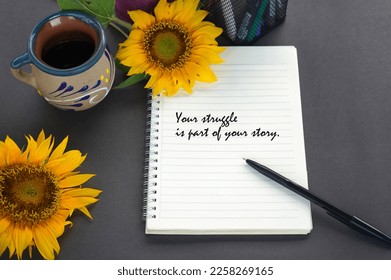 Life story inspirational quote - Your struggle is part of your story. Text on notebook with pen, coffee cup and sunflowers decoration on the gray table background. Life journey concept. - Shutterstock ID 2258269165