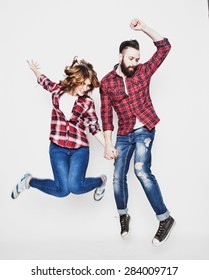 life style, happiness and people concept: Happy loving couple. Jumping over light grey background. Special Fashionable toning. - Shutterstock ID 284009717