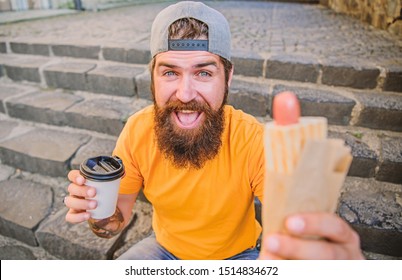 Life Tastes Better With Hot Cuisine. Hipster Having Traditional Hot Dog Cuisine During Rest Break. Caucasian Guy Enjoying Street Cuisine. Bearded Man Eating Unhealthy Fast Food Cuisine.