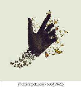 Life Transformation Concept Image Of Butterflies Flying Out And Around Of Black Painted Hand. Isolated Background. Abstract Symbol Of Freedom Or Dream, Hope Renewal And Spirituality Or Human Faith