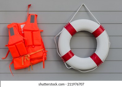 life vest and life belt on wooden wall