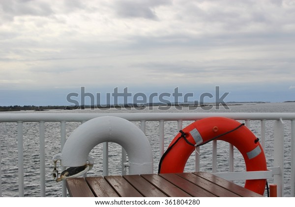Lifebelt on the deck of a small ferry in Norway,\
on the North Sea. The ferry is on the way from Haugesund to the\
island Utsira.