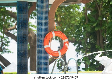 Lifebuoy By The Pool. Orange Swim Ring.