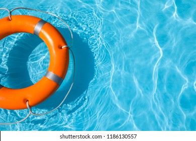 Lifebuoy floating in swimming pool on sunny day. Space for text - Powered by Shutterstock