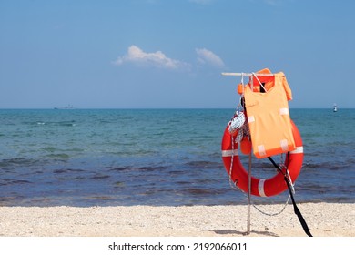 Lifebuoy On The Beach. Life Jacket On The Beach. Water Safety.