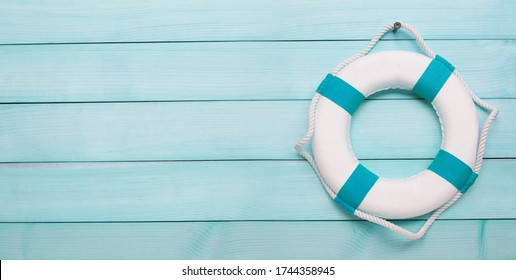 Lifebuoy on concrete wooden wall background. Copy space